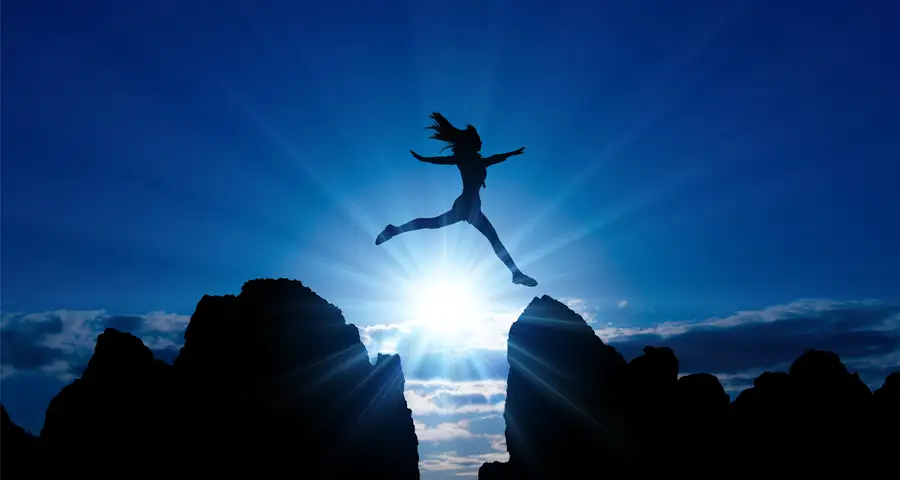 mujer atravesando de un salto un obstáculo